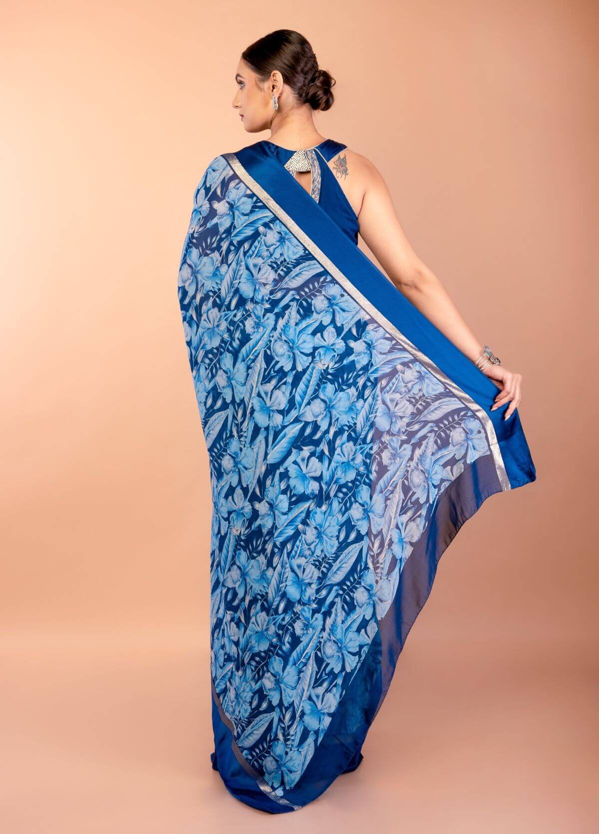 Matching blouse piece included with blue floral georgette saree set
