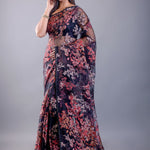Model in black tissue silk saree with subtle sheer texture and all-over printed floral pattern, with delicate shimmer finish, shown with sample blouse — party and festive wear