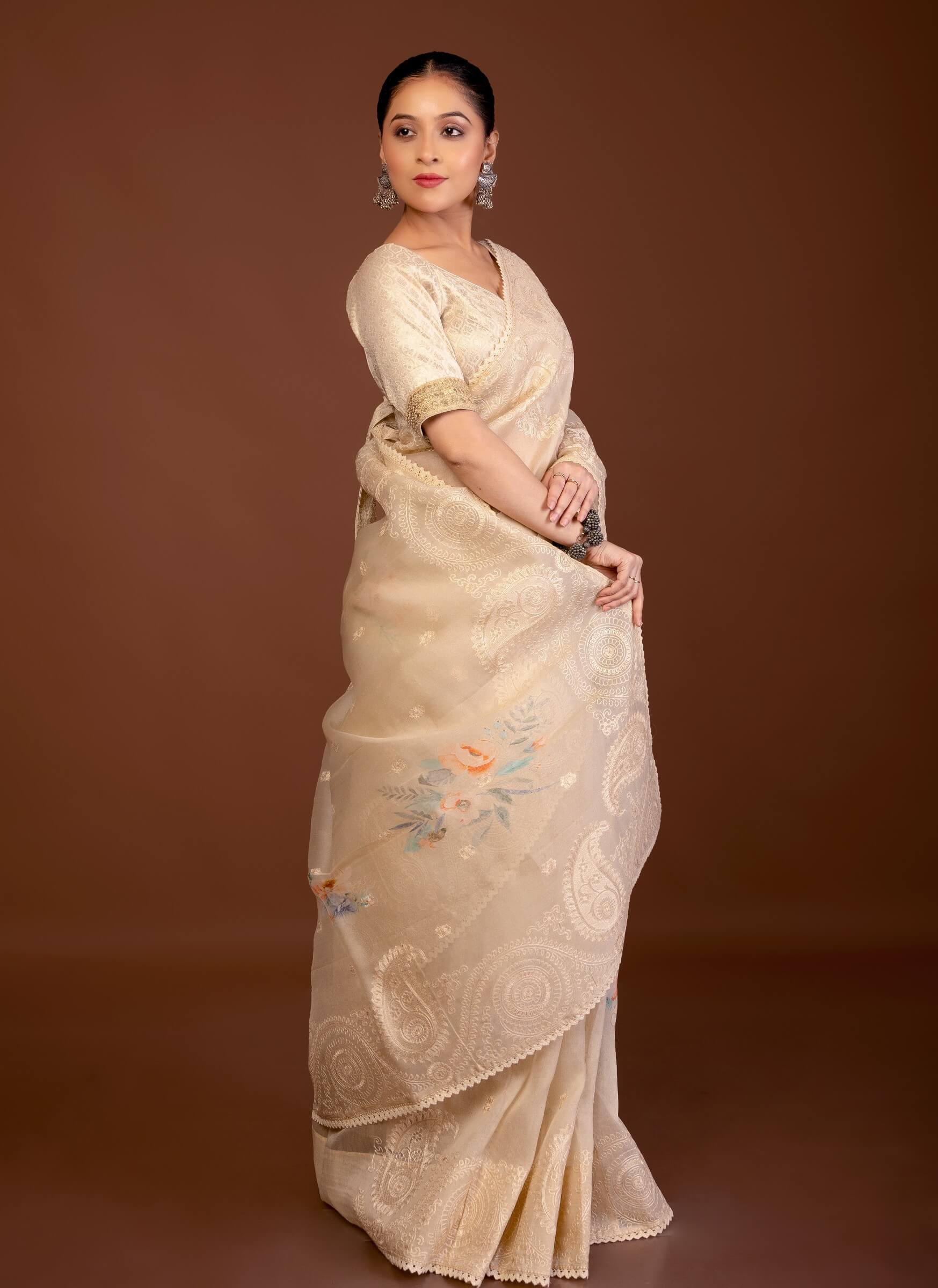 Off-white organza saree — side view showing printed floral embroidery and lace trim along border