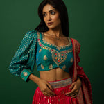 Pink Banarasi Weave Lehenga Set — Peacock Blue Choli embroidery close-up