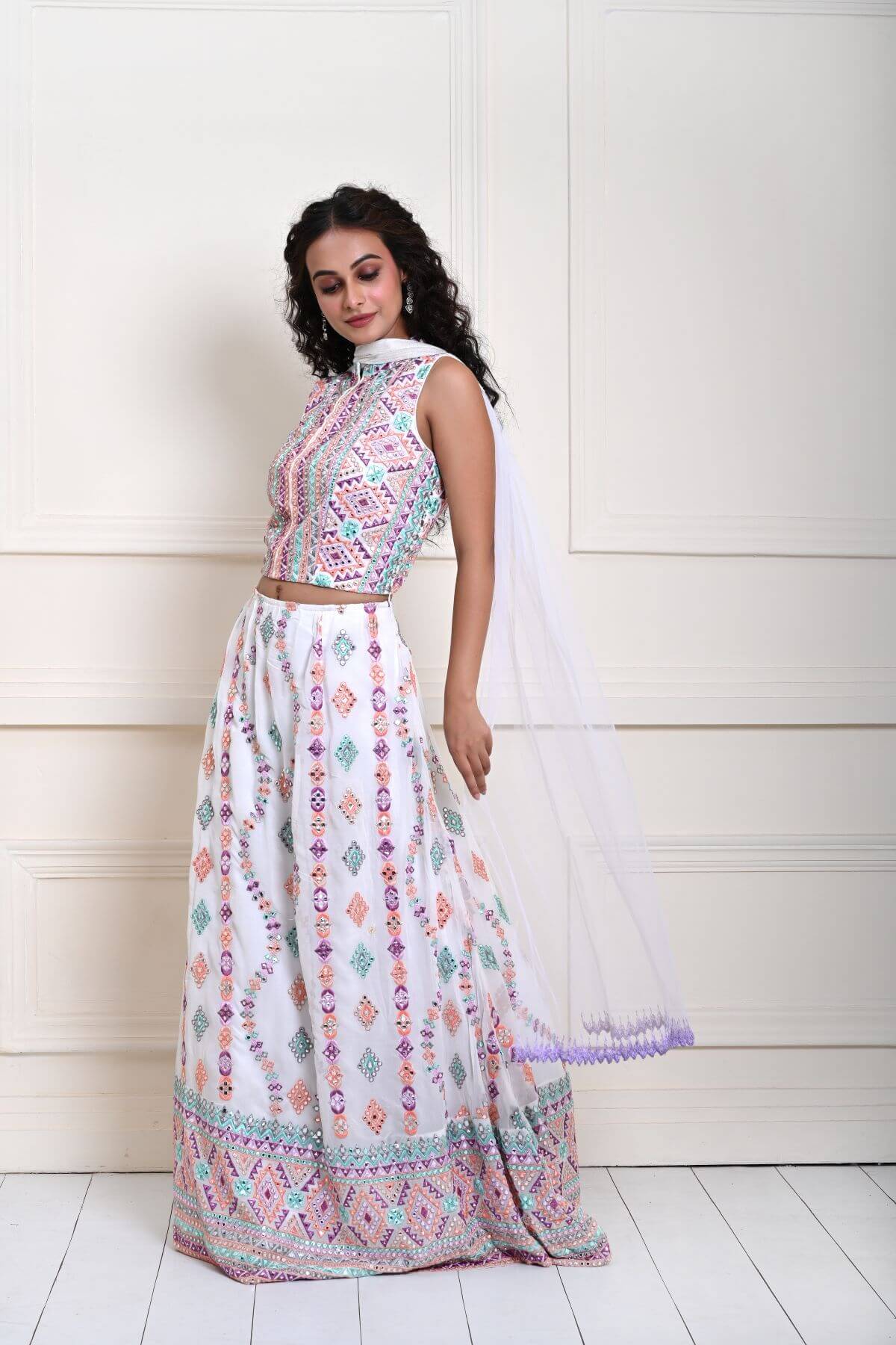 Pure White Georgette Lehenga — close-up of multicolor embroidered mirror work on skirt