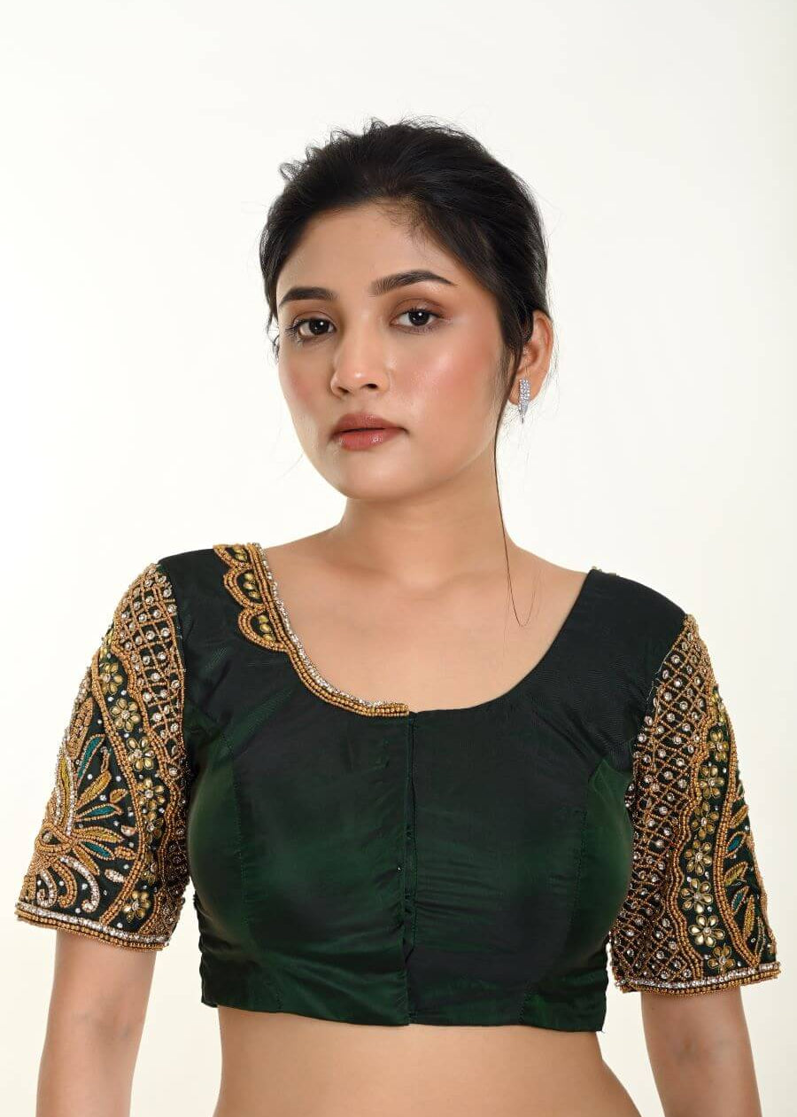 A Woman Wearing a Green Bridal Blouse in Pure Silk with Maggam Zardozi Work: Bridal Blouse - Anvi Couture - Image 1