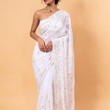 Sheer white net saree with delicate all-over white floral embroidery in resham thread and stone detailing, with unstitched blouse piece