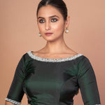 Side profile of dark green silk boat neck blouse with embroidered sleeves