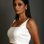 Side profile of lightweight white sleeveless blouse in breathable cotton fabric
