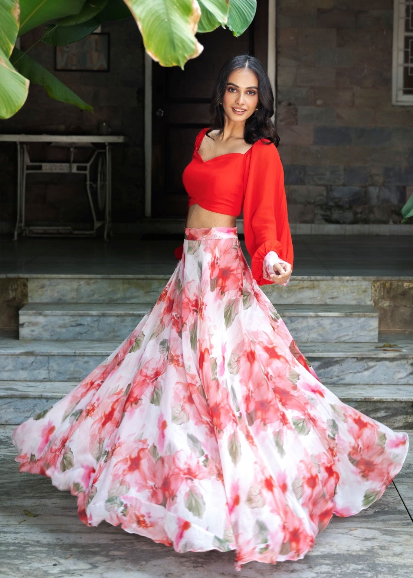 Soft bloom white and orange floral lehenga — side view showing full flared skirt and dupatta styling