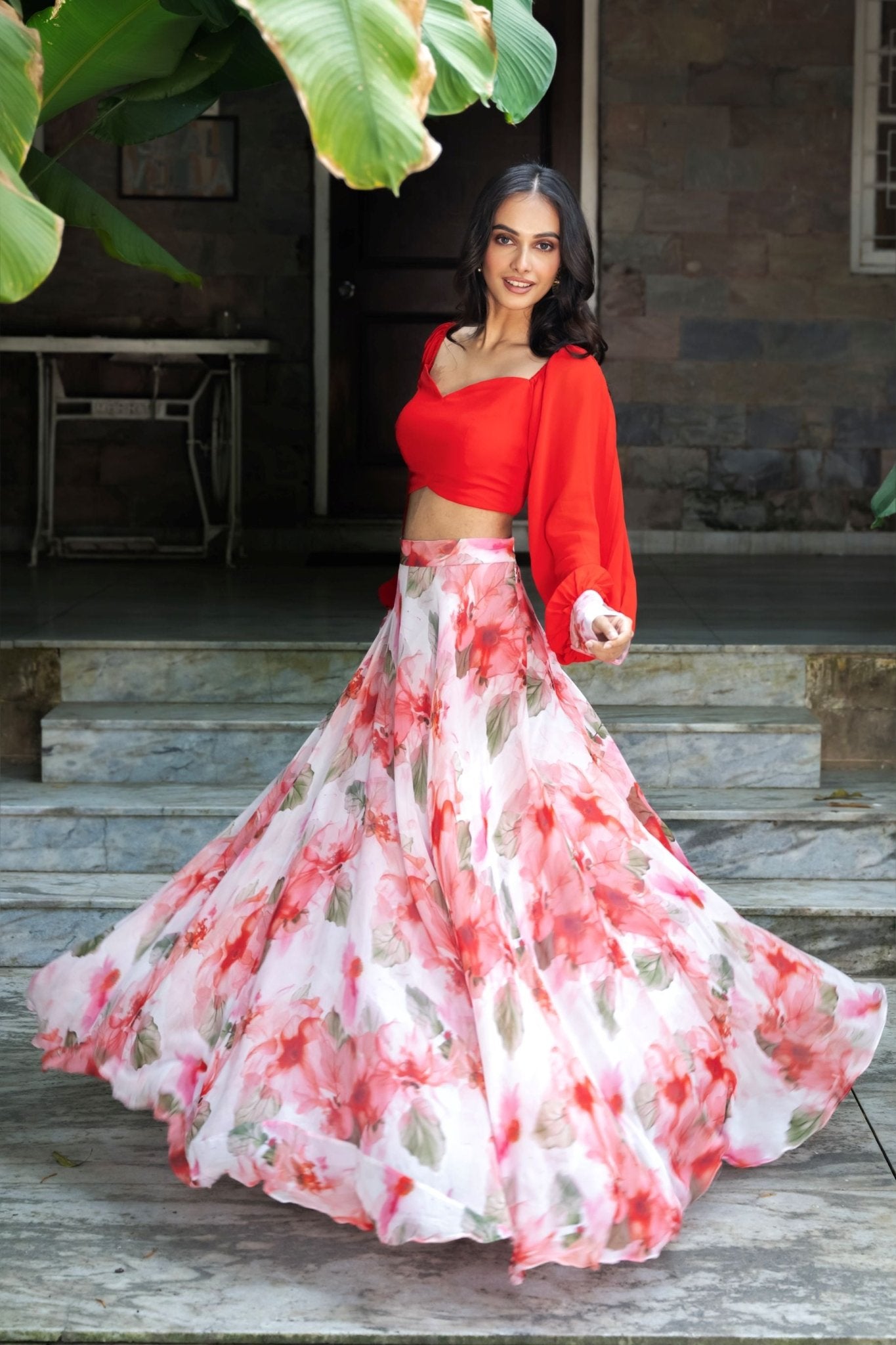 Soft bloom white and orange floral lehenga — side view showing full flared skirt and dupatta styling