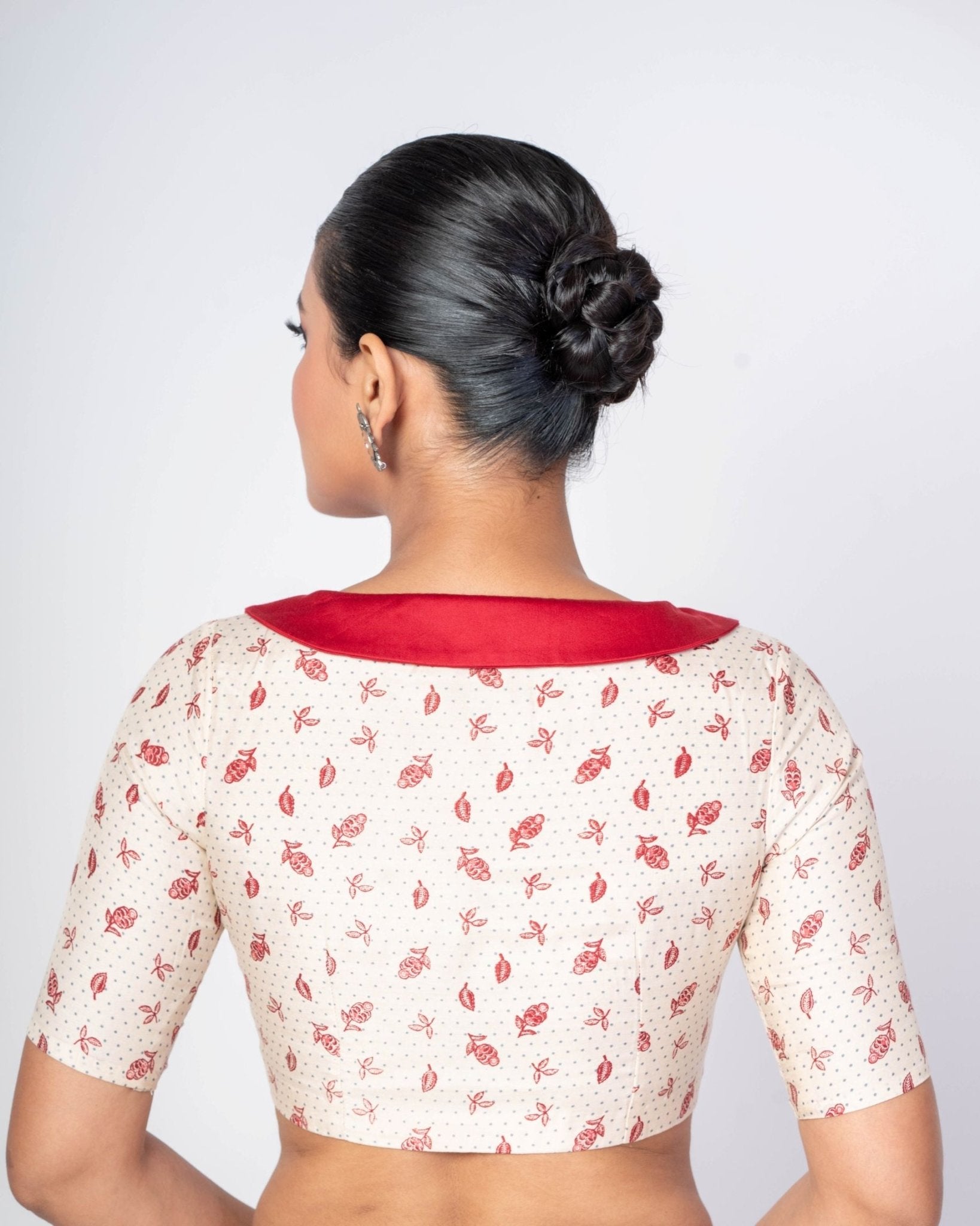 Close up White floral printed collar neck blouse with elbow sleeves for a modern saree look