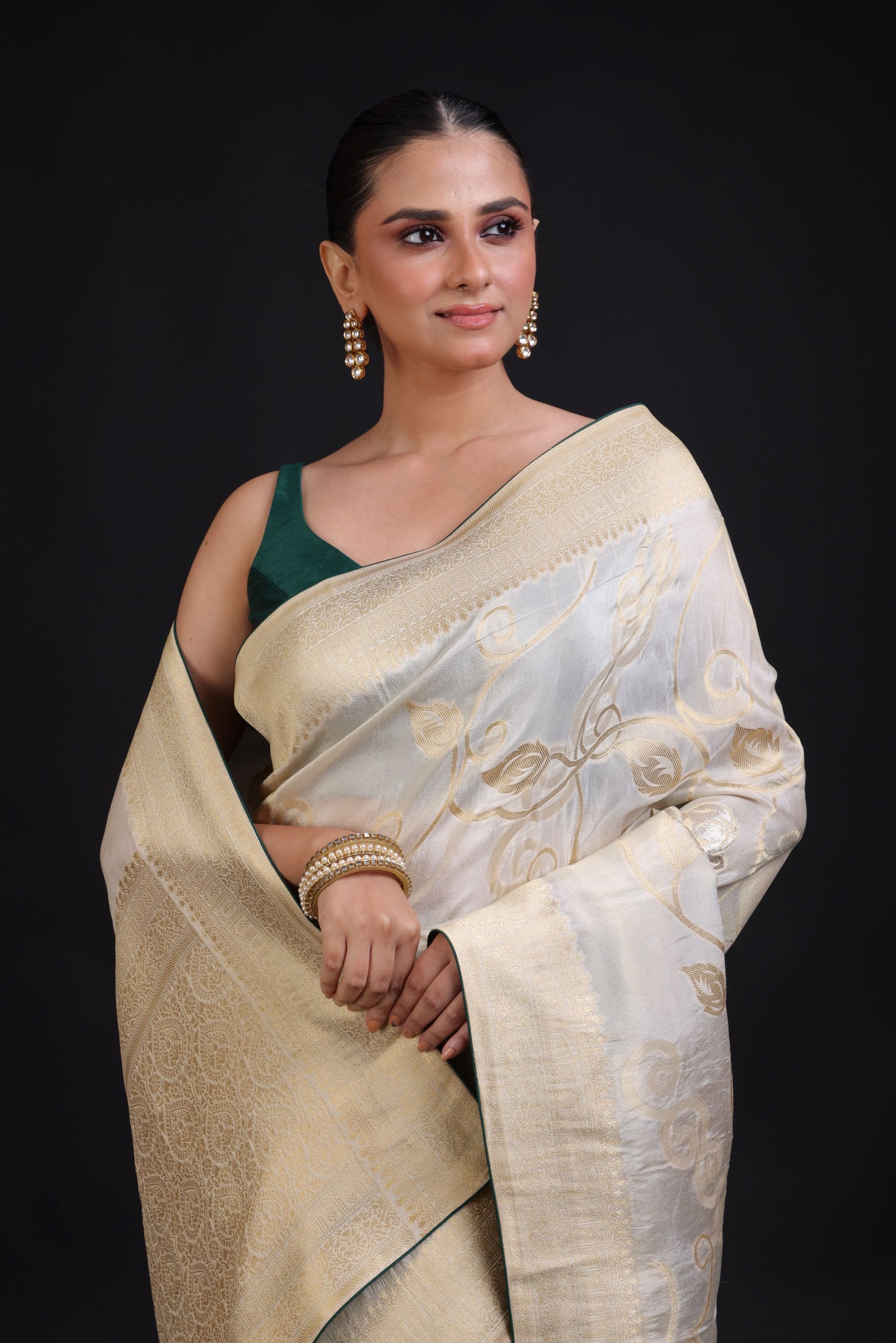 White and Gold Banarasi Saree with Green Piping finishing close up