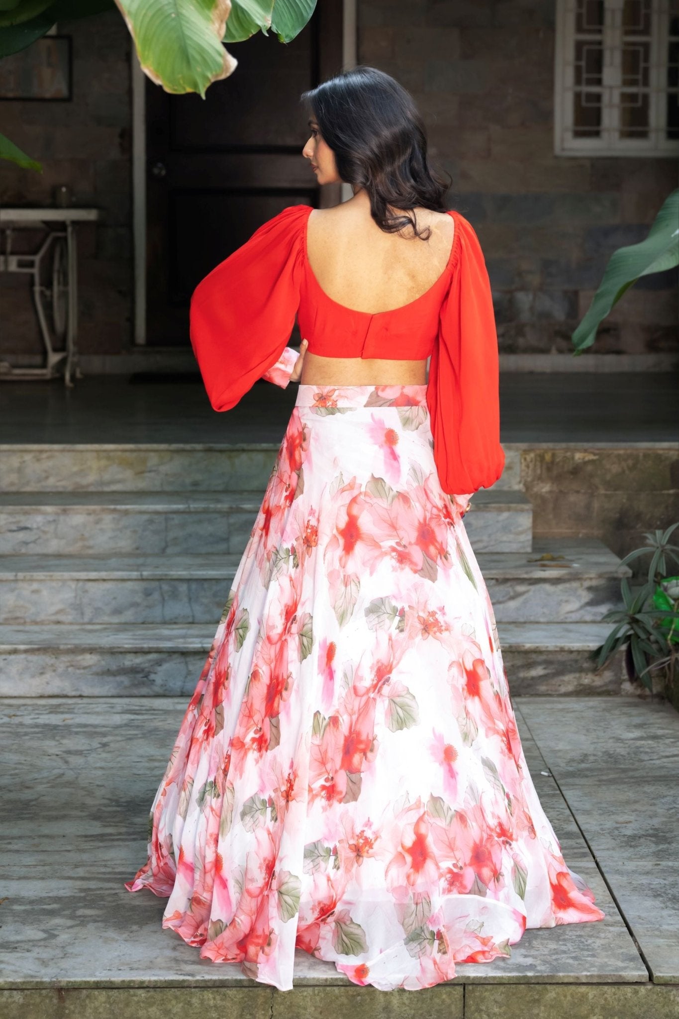 Soft bloom white and orange floral lehenga — back view of full flared skirt and dupatta drape