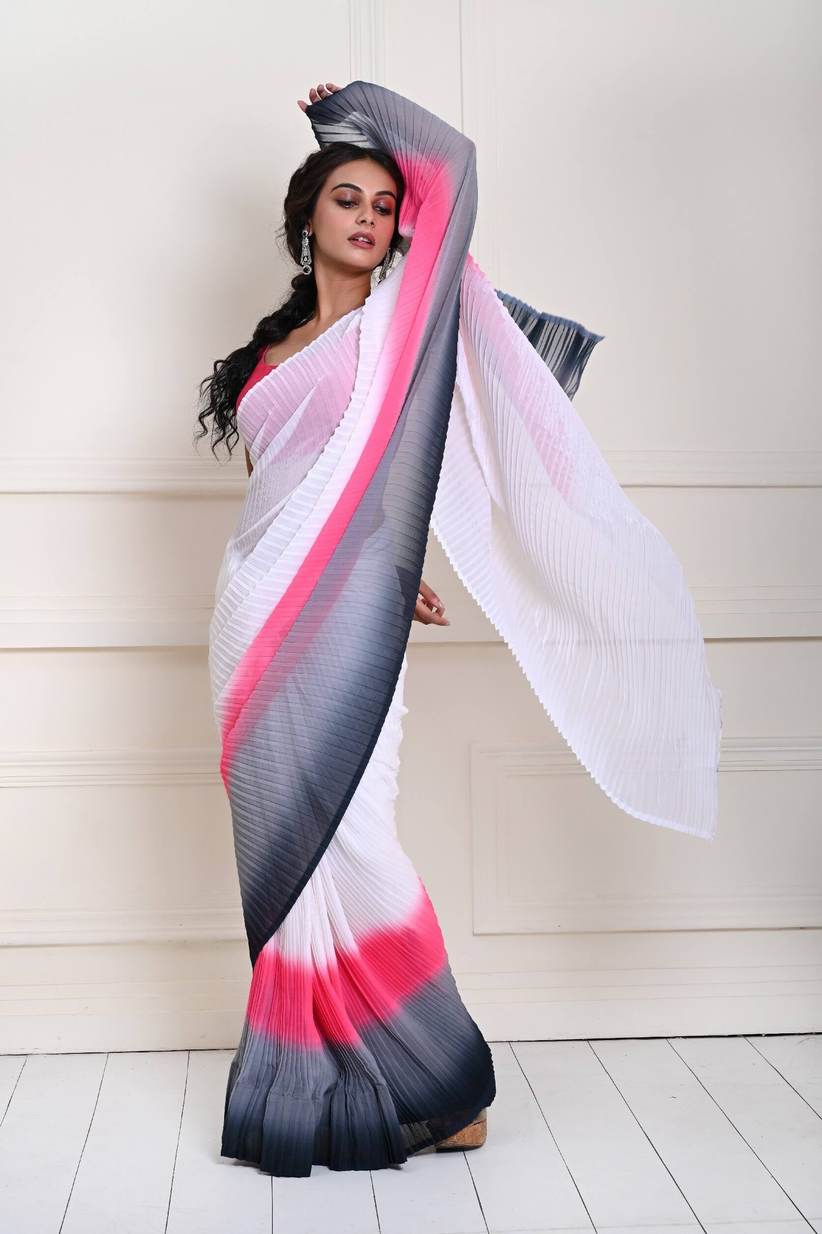 Close-up of pleated drape on white ombre pure georgette saree