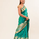 Woman wearing a light blue and gold temple border Katan Banarasi Silk Saree