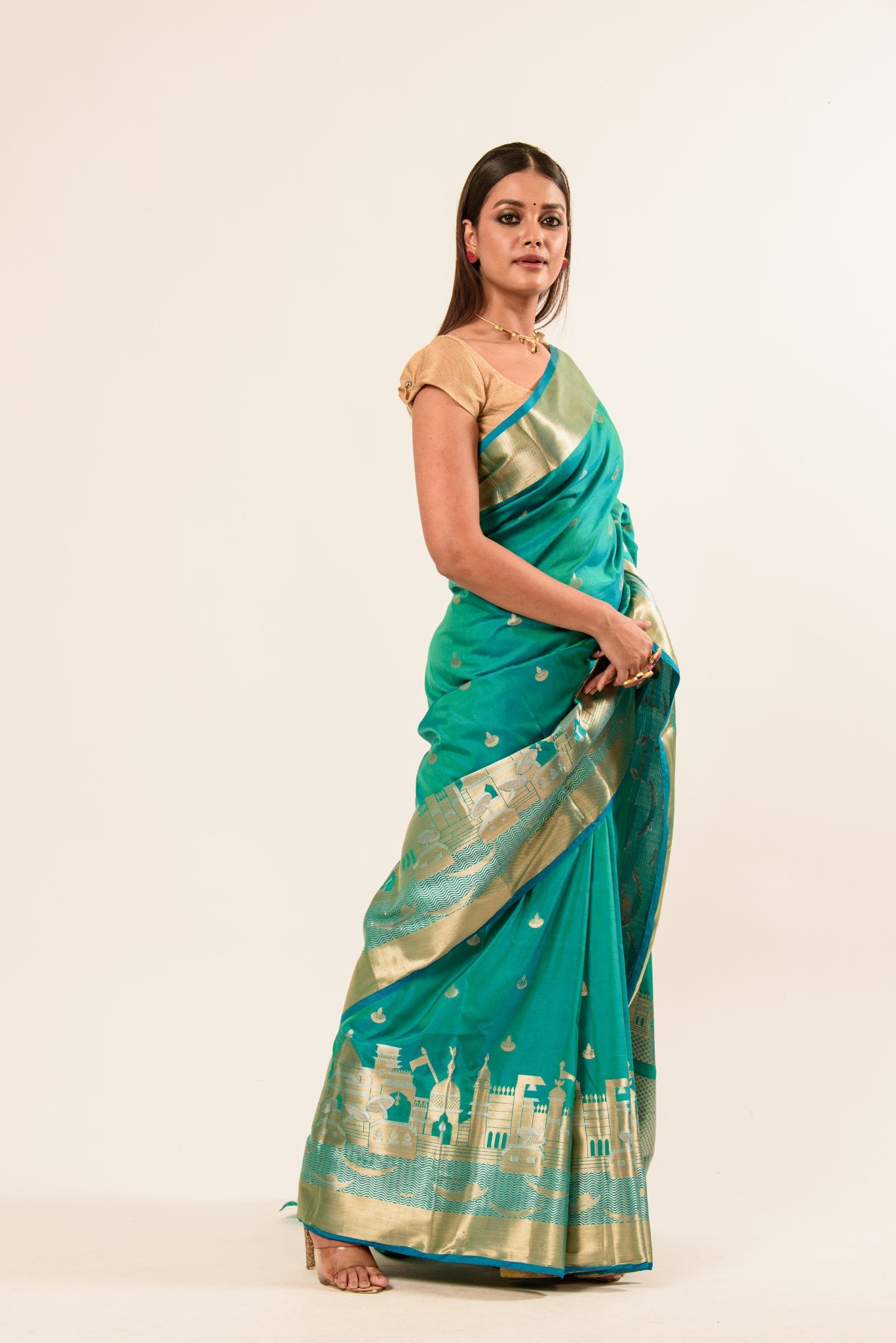 Woman wearing a light blue and gold temple border Katan Banarasi Silk Saree - Image 3