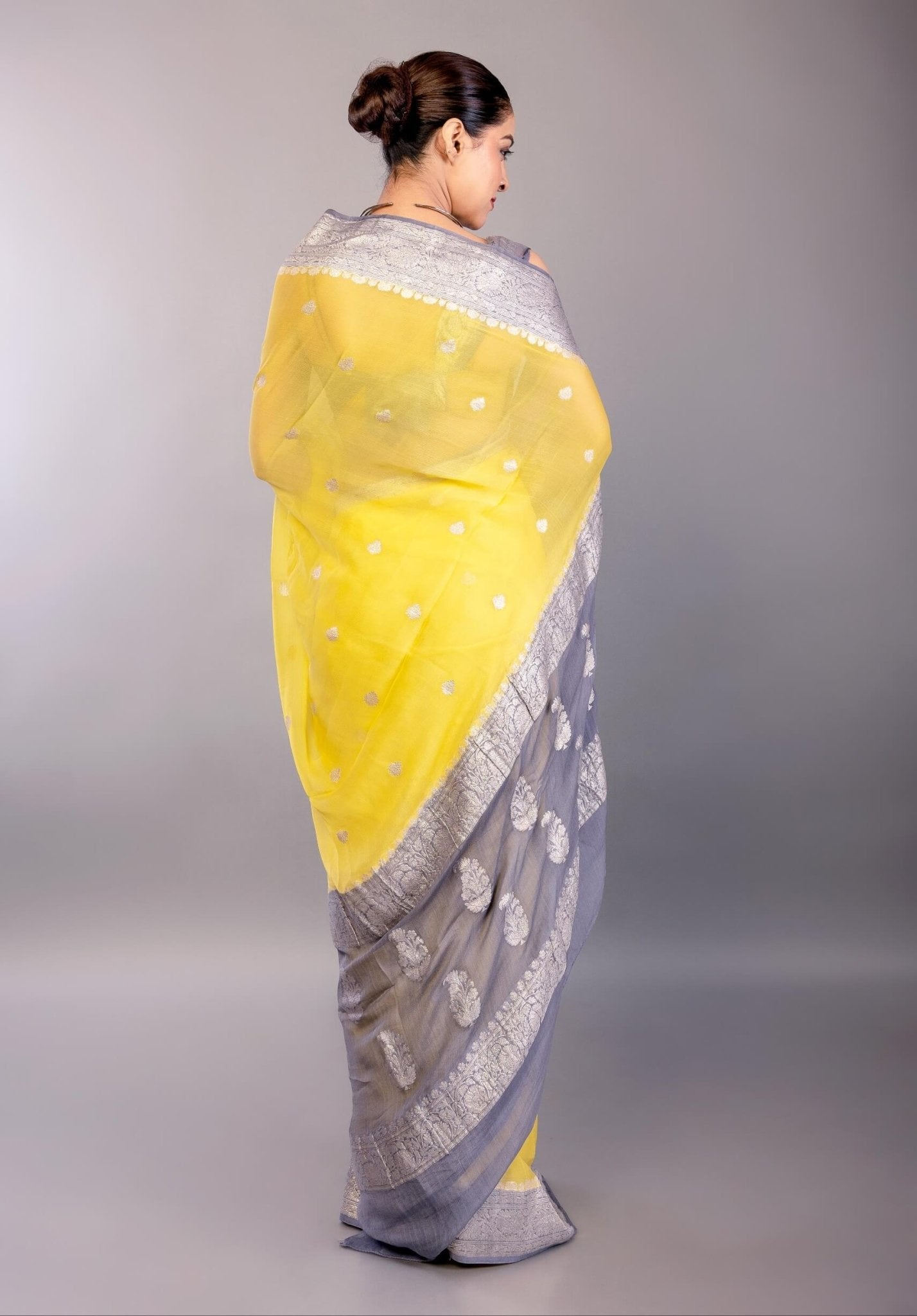 back view showing full pallu spread of the yellow Banarasi saree