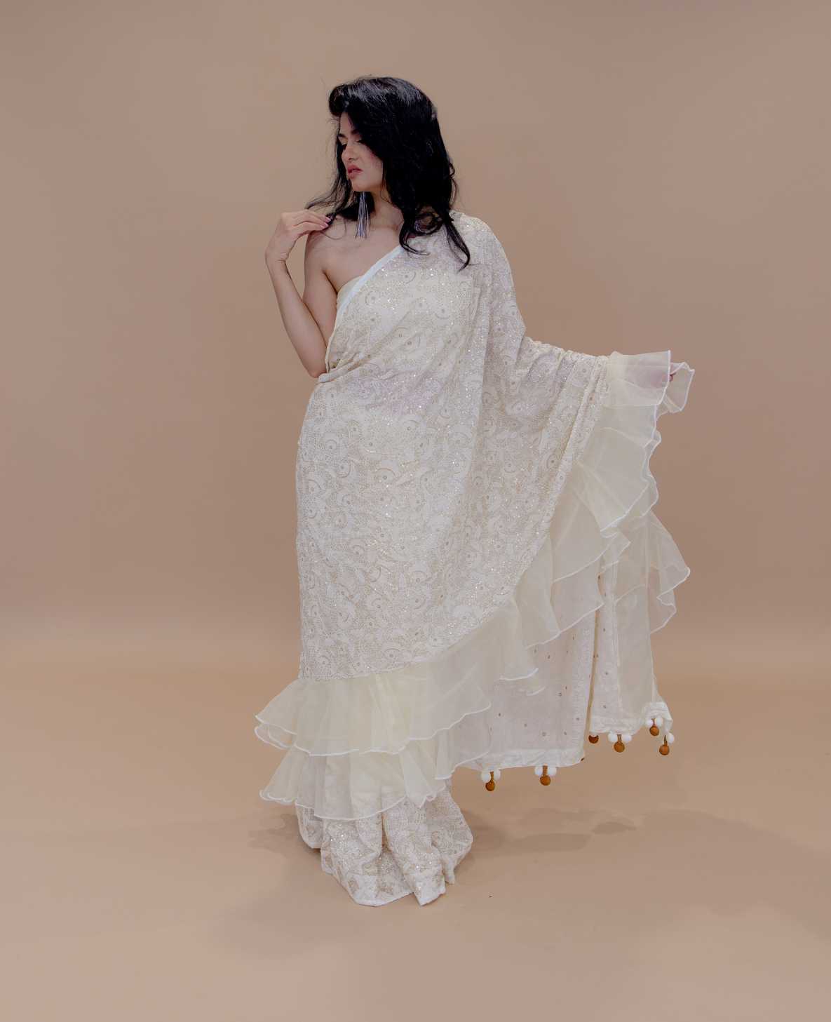 Discover the elegant Georgette Chikankari Ivory Designer Ruffle Saree with Tassel Pallu, exclusively from Anvi Couture.