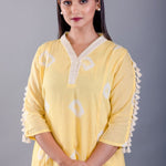 close-up of white tassel detailing on hemline - Anvi Couture