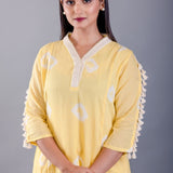 close-up of white tassel detailing on hemline - Anvi Couture