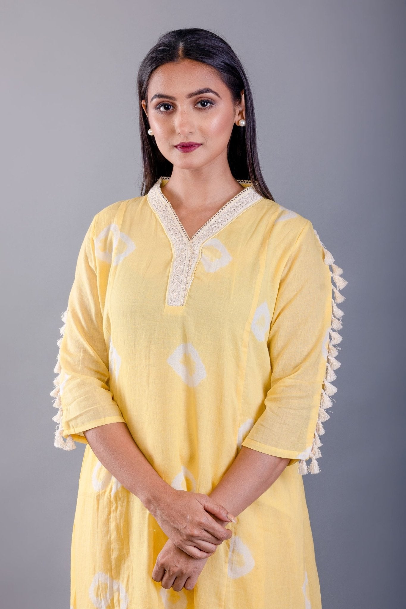 close-up of white tassel detailing on hemline - Anvi Couture