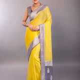 front drape view showing yellow georgette body with gray zari border
