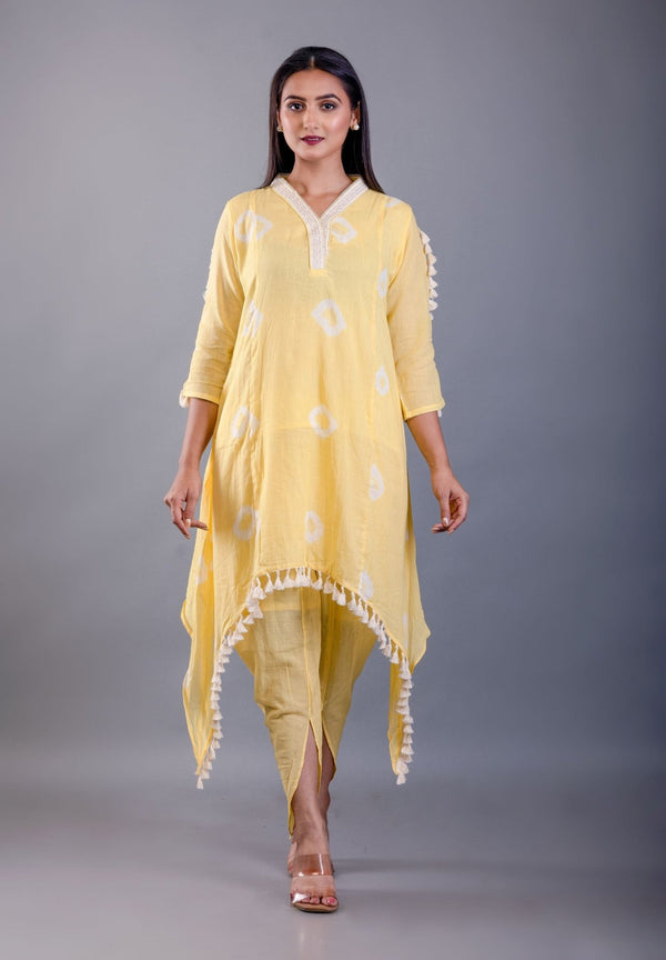 front view showing butter yellow dhoti pants and white tassel trim on kurta