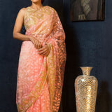Model wearing a deep pink net saree with dense sequin embroidery in large floral motifs, featuring stonework, suitable for cocktail and reception occasions